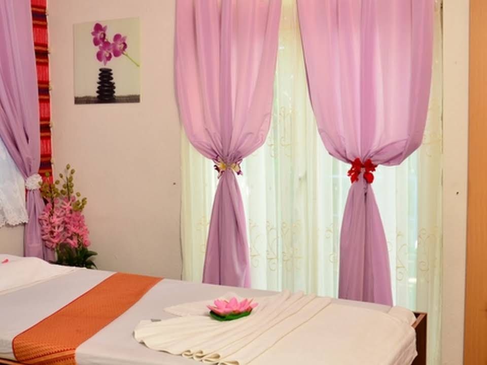 Frisch bezogene Massageliegen mit Lotus-Handtuch